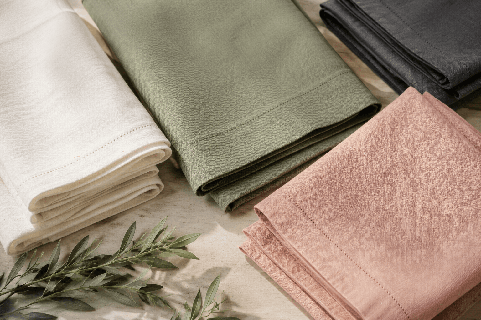 Stacks of plain folded table linens ready for a bulk order
